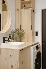 The custom cabinetry for the bathroom is made of laminated pine board with a water-base finish that's resistant to color change and similar to what you see in the rest of the house as we wanted  to create a consistent story,