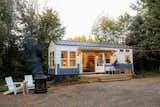 Handcrafted Hideaway, a 264-square-foot house that Elizabeth and Matt Impola of Handcrafted Movement designed and built is situated on a lush property in Battle Ground, Washington, with towering trees, a large pasture, and abundant wildlife.