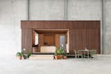 The built-in wood bed folds down from the living room wall at night. During the day, it can fold back into the wall to free up floor space for the interior of the tiny home.