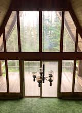 The living area's views of evergreens and the lake helped to inspire the Colemans to purchase the cabin.