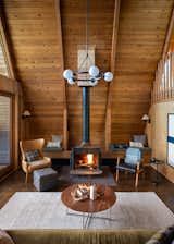 The builders restored the cast-iron Franklin Stove in the living room, where built-in benches provide additional seating for reading and relaxing by the fire.