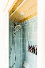 <span style="font-family: Theinhardt, -apple-system, BlinkMacSystemFont, &quot;Segoe UI&quot;, Roboto, Oxygen-Sans, Ubuntu, Cantarell, &quot;Helvetica Neue&quot;, sans-serif;">Aqua subway tile provides a coastal feel for the bathroom. "Since we're pretty conscious about weight, we built the bathroom using metal studs and Schluter Kerdi Board, which is a super lightweight material,