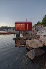 Exterior, Wood Siding Material, Metal Roof Material, Gable RoofLine, Boathouse Building Type, Cabin Building Type, and Tiny Home Building Type The angled boards of the exterior siding are open toward the front of the structure, connecting the tiny cabin to the environment.  Photo 8 of 9 in This Tiny Boathouse in Norway Is a Private Retreat in Plain Sight