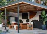 Dobrinski painted the existing brick wall in the outdoor dining area, applying geometric forms that lend a whimsical note.