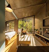The interiors of the cabins showcases a concrete ceiling and walls and wood flooring.