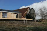 The wood-wrapped home blends seamlessly with the existing farm buildings, which have been in the family for generations.