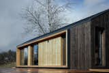 The tiny home's cross-laminated timber siding features caramel and chocolate-colored tones that reference colors found in nature.