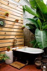 An outdoor tub on the terrace of one of the tiny homes provides a place to relax and experience an herbal bath.