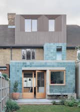 Architect Grant Straghan remodeled his 1930s family home in London with a rear extension clad in blue-green cement tile.