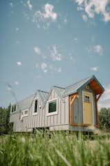 Fritz Tiny Homes designed and built a 32-foot-long tiny house for Vince and Ayşe Macdonald, a retired couple from Ottowa, Canada. The home is clad in standing-seam metal, and the roof is topped with solar panels. “This home is fully off-grid, with an autonomous solar system, 100-gallon fresh and graywater tanks, a UV and particulate water filtration system, hydronic in-floor heating, and a mini split air conditioning system—it’s ready for any climate,” Kevin says.  Photo 2 of 15 in A Retired Couple Set Out for Adventure in an Off-Grid Tiny House