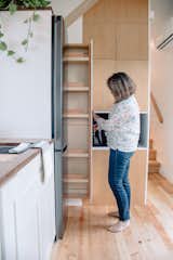 A slim pull-out pantry beside the LG refrigerator offers added storage for kitchen items without taking up too much floor space.