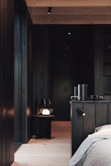 The designers affixed small reading lights on each side of the headboard in the bedroom area to facilitate nighttime reading.  Photo 7 of 11 in A Svelte $79K Prefab Cabin Promises to Work as Well in Your Backyard as It Does in the Woods