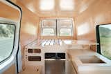 The large kit features a double bed, a kitchen, a workspace, and plenty of storage.