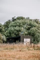The tiny prefab cabins Koto designed for Trees at Tughall, a resort on the Northumberland Coast of England, feature 300-square-foot plans that prioritize a connection with the outdoors. The exteriors are clad with vertical Welsh spruce siding that’s been stained black.