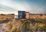 MuuwSpace, a prefabricated hexagonal cabin wrapped in glass, metal, and wood, measures almost 100 square feet and features a starting price of $32K.