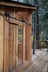 A custom barn-style door made from glass and Douglas fir accesses the deck and showcases hardware that was repurposed from a 1910 building on the property.