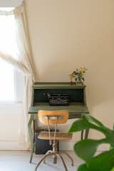 LaTonya painted a small desk that came with the home an olive-green shade and placed it in the primary bedroom, where she writes often.