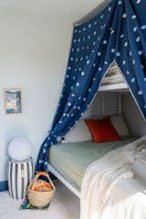 In the kid’s room, the bunk beds can be sectioned off by fabric curtains to create the feeling of a fort.