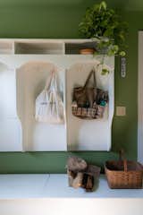 In the mudroom, green wall paint from Farrow & Ball ties the space to the outdoors.
