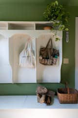 Green wall paint from Farrow &amp; Ball in the mud room ties the space to the outdoors.  Photo 14 of 14 in Meet the Women Who Reimagined a Hudson Valley Farmhouse as a BIPOC Residency