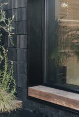 Deep window ledges on the exterior act as small stoops, where the client Wayne Euston-Moore often takes phone calls.