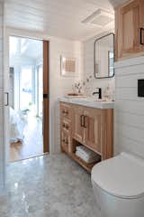 A hickory vanity and hexagonal floor tile enliven the bathroom.  Photo 11 of 13 in Budget Breakdown: A $237K Tiny Home on Wheels Brings Kids, Parents, and Their Parents Together