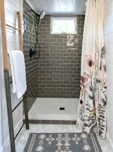 Grayish-green shower tile provides a dramatic note in the bathroom.  Photo 12 of 13 in Budget Breakdown: A $237K Tiny Home on Wheels Brings Kids, Parents, and Their Parents Together
