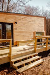 The prefabricated cabin features timber cladding and a matching deck.