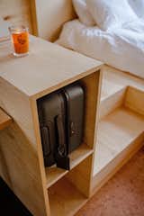 Built-in storage between the work station and the bed provides a place for luggage.