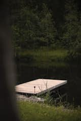A pond with a dock provides a place to launch boats or swim.