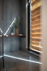 A wood shutter closes the shower to the outdoors when guests want a feeling of privacy.
