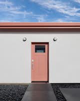 A pink-painted front door and fascia enliven a 500-square-foot backyard ADU in Mountain View, California, designed by Shin Shin Architecture.