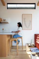 Jyotsna works at the concrete counter, which functions as both a dining area and an office.