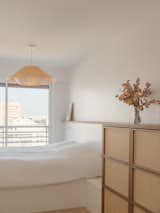 Sliding glass doors connect the bedrooms to city views.