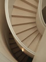 European oak treads contrast with a microcement railing, lending subtlety and texture.