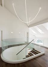 The designers wrapped the staircase in glass, giving the feature an ethereal quality.