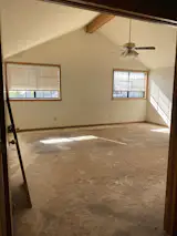 A 1980s fan and horizontal blinds gave the primary bedroom a feeling of being stuck in time.