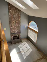 The upstairs view of the double-height living room was previously uninspired.