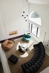 The upstairs view of the new living room now has a warm, inviting, and artful appearance.