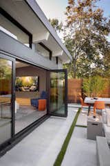 Massive glass folding doors connect the living area to the rear yard.