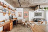 <span style="font-family: Theinhardt, -apple-system, BlinkMacSystemFont, &quot;Segoe UI&quot;, Roboto, Oxygen-Sans, Ubuntu, Cantarell, &quot;Helvetica Neue&quot;, sans-serif;">The architects created an office for two in the open living area by arranging a Freijó wood desk along the wall. Shelving above the desk holds Carolina and Marcus's book collection, and the armchair and ottoman, designed by Sergio Rodrigues, were acquired at auction; the poster is by Shepard Fairey. The sitting area is outfitted with a family heirloom coffee table, a sofa by Cini Boeri, and a Jackson Pollock print.</span>