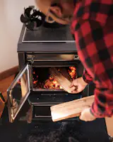 Malcom's goal is to build the perfect fire in the living room's vintage Kent stove.