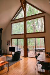 A massive wall of windows connects the living and dining areas to the outdoors.