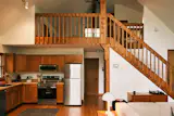 The couple updated the kitchen with Samsung appliances and maintained the cabin's original oak cabinetry and stair rail.