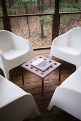 Molded plastic lounge chairs from Ikea offer additional places to sit on one of the decks.