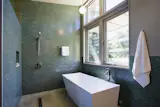 Solar hot water panels provide domestic hot water for the house, and the pool. The master bath receives daylight from two sides through the high transom windows.