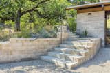 Watershed Block earth masonry retaining walls limited the number of concrete deliveries at the remote location, and provided a warm, variegated texture.  Photo 6 of 21 in Healdsburg Family House by Arkin Tilt Architects