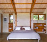 Straw bale walls with buff-colored lime plaster and douglas fir posts, beams and trusses are left exposed adding visual warmth at the interior.