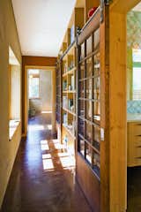Tucked behind the bookshelves in the master bedroom hall, the bath and master closet look out on the redwoods to the west.