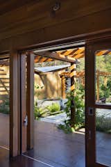 A scupper throws rainwater into a fountain below, bringing variations in sound and light to the courtyard.  Photo 3 of 15 in Vine Hill Straw Bale Residence by Arkin Tilt Architects